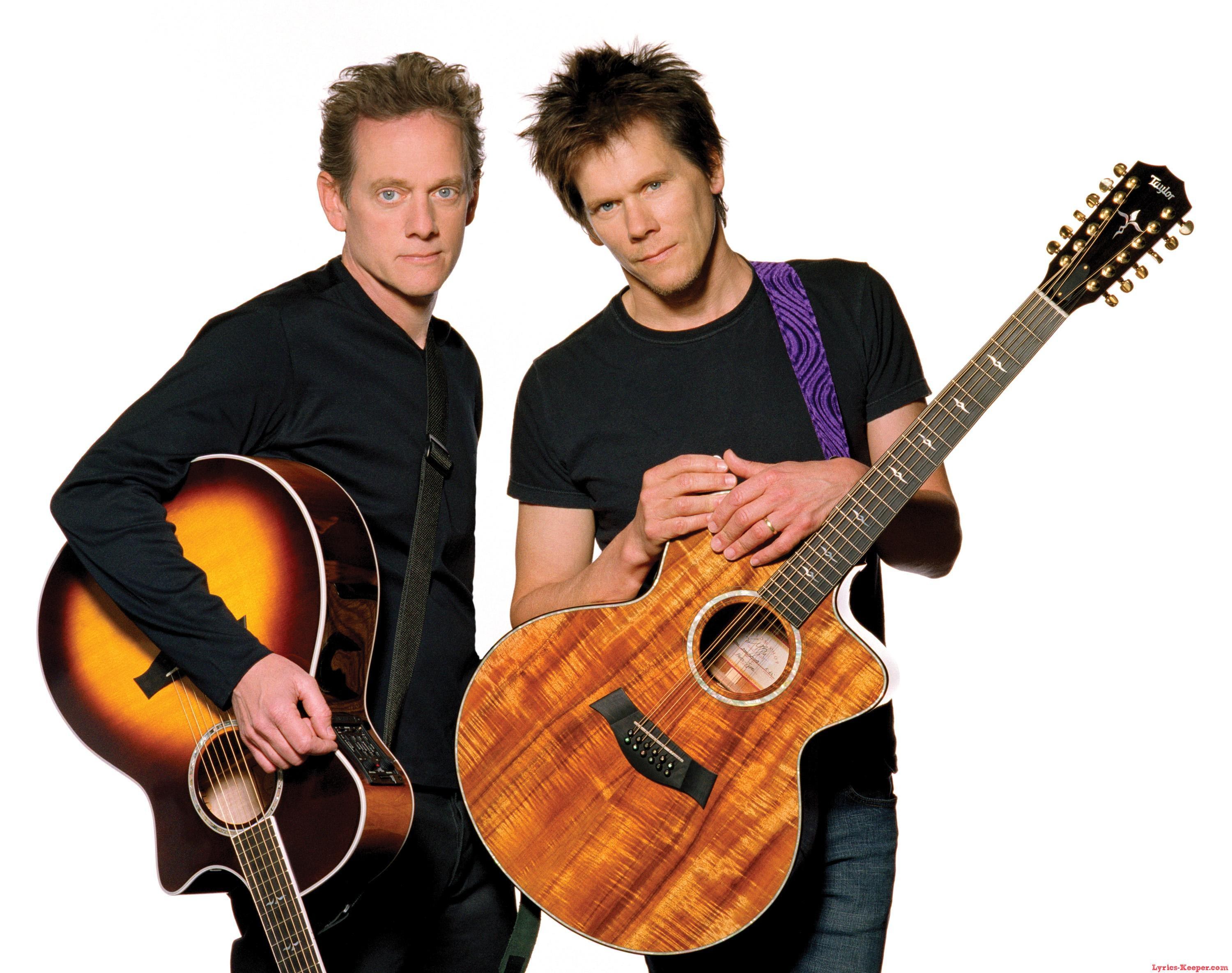 two musicians with acoustic guitars