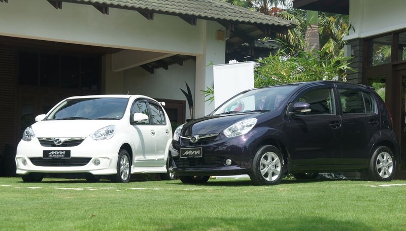 Two Myvi cars on a lawn