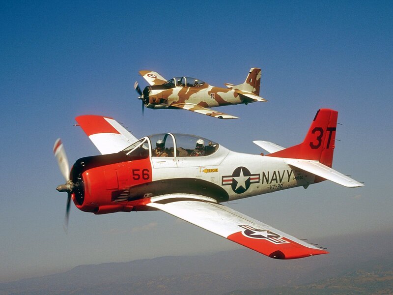 Two Navy training aircraft in flight