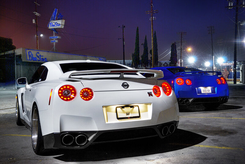 Two Nissan GT-Rs at night