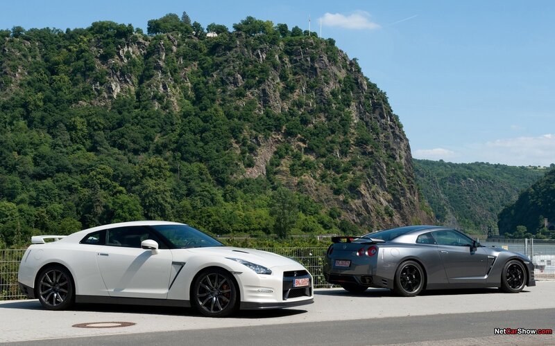 Two Nissan GT-Rs on a scenic road