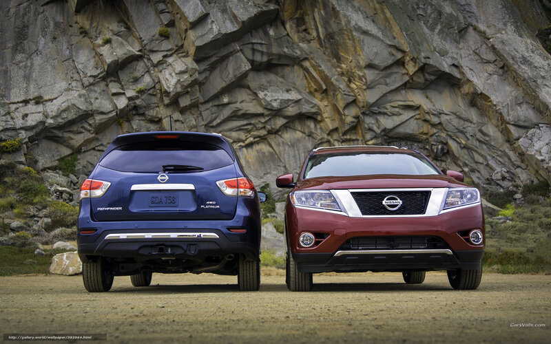 Two Nissan SUVs in a rocky landscape