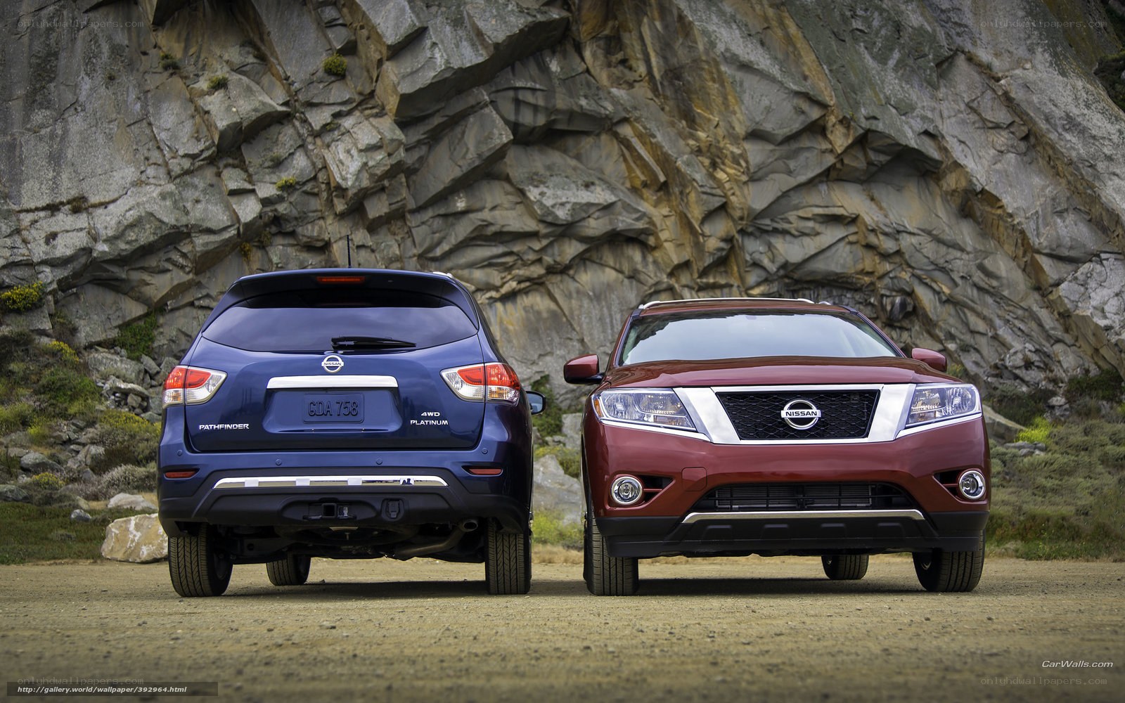 Two Nissan SUVs in a rocky landscape