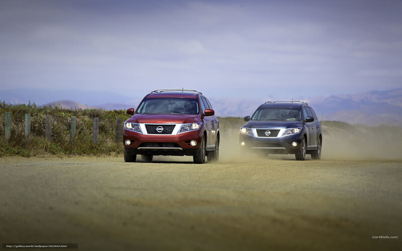 Two Nissan SUVs on a dirt road