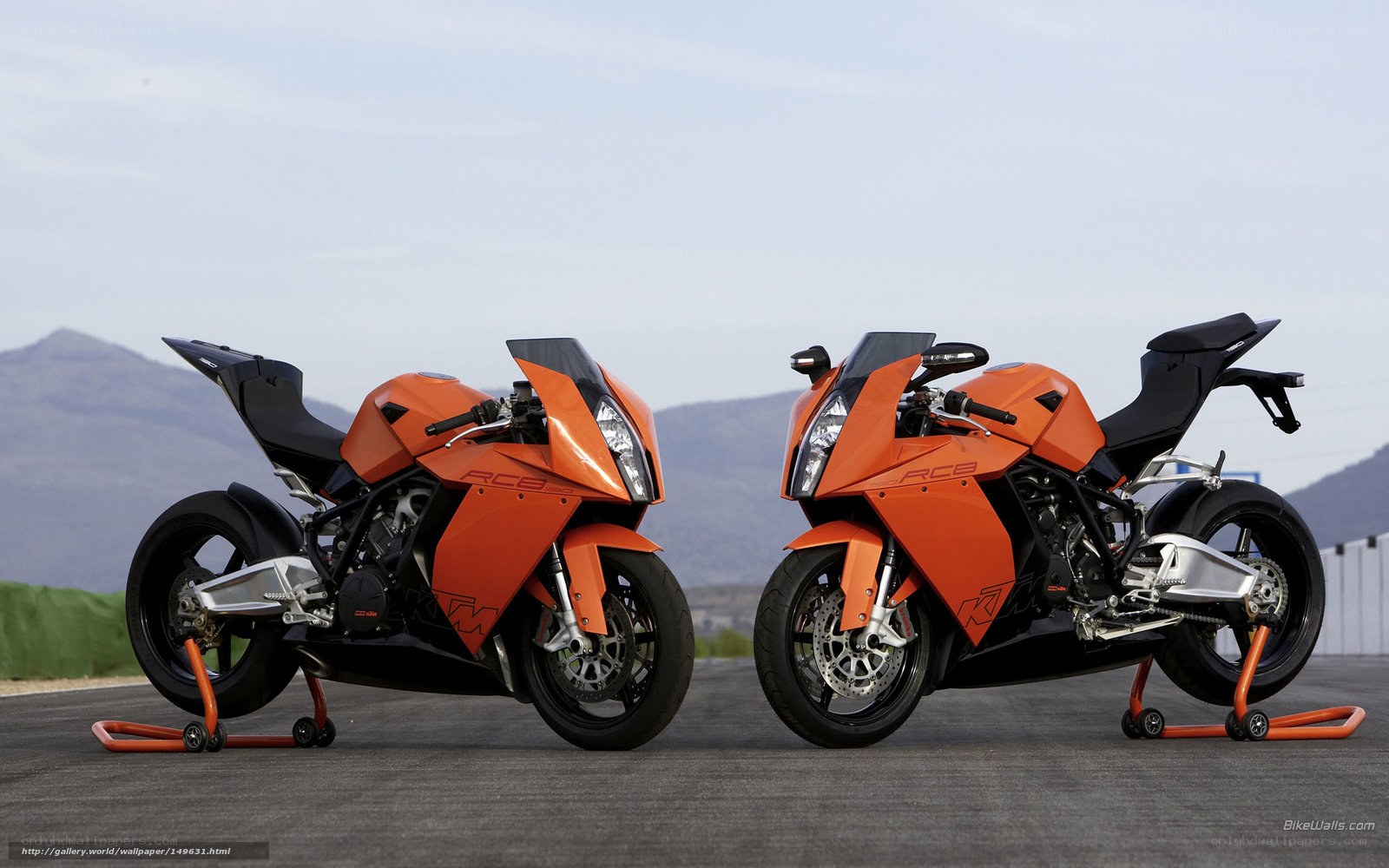 Two orange KTM RC8 motorcycles