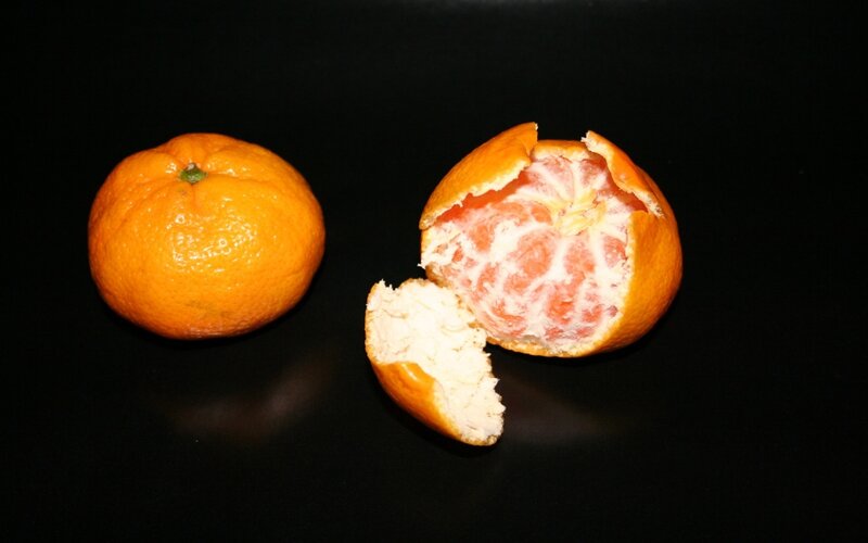 Two oranges on black background
