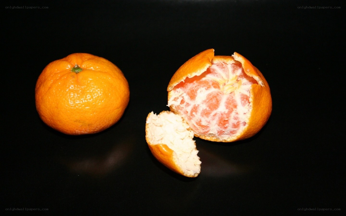 Two oranges on black background