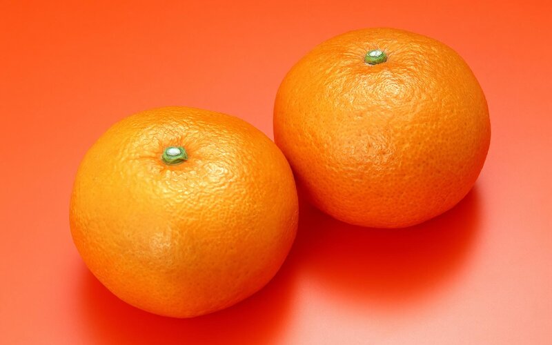 Two Oranges on Red Surface — Orange