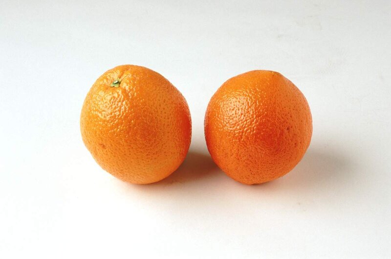 Two oranges on white surface