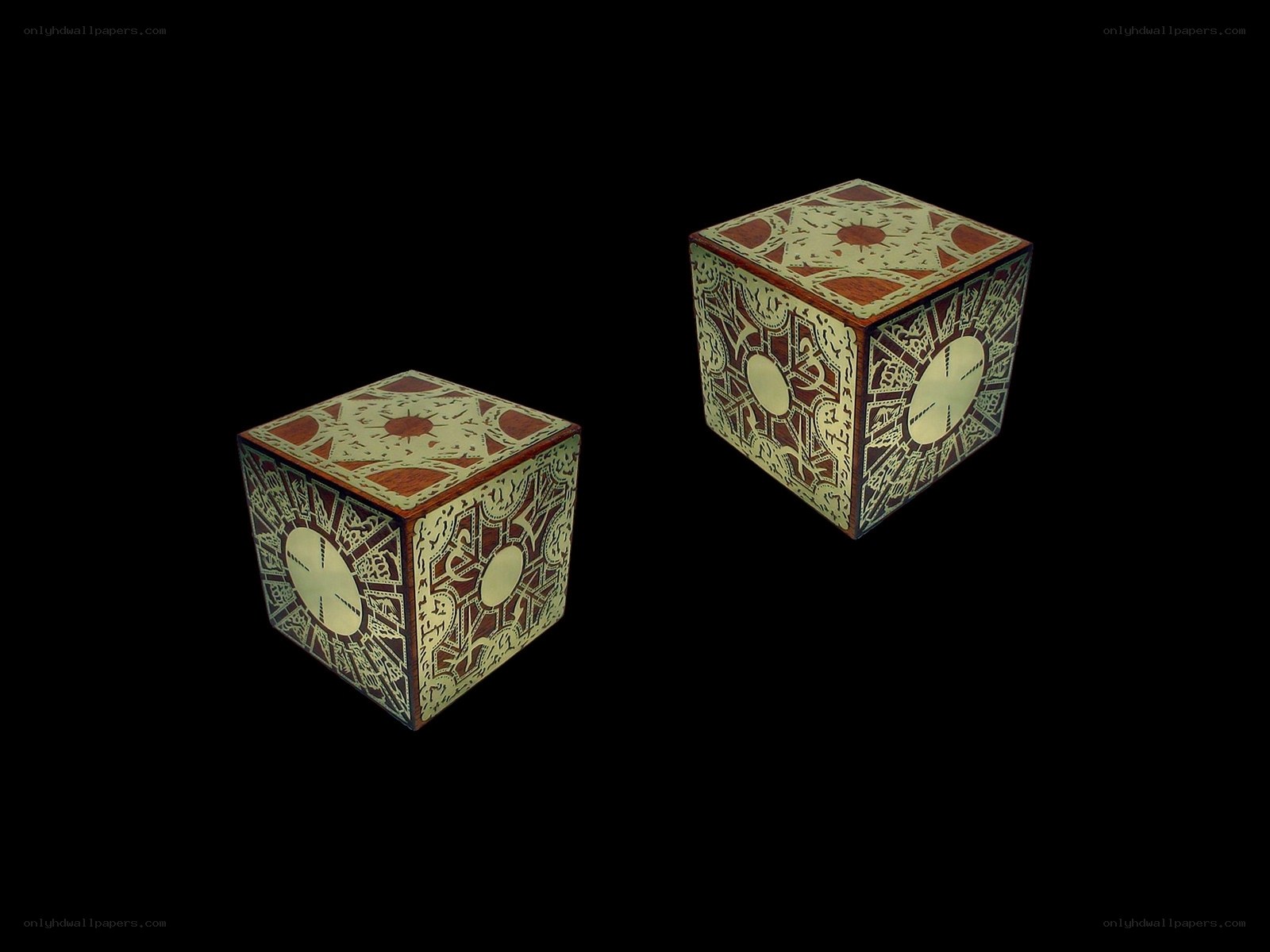 two ornate cubes on black