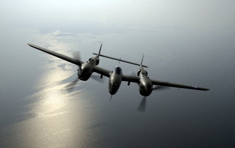 Two P-38 Lightning aircraft in flight