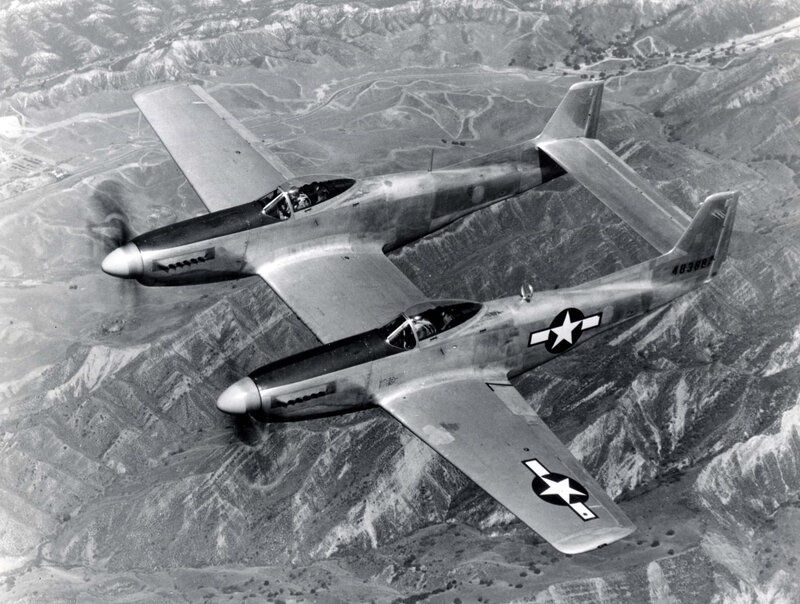 Two P-51 Mustangs in flight