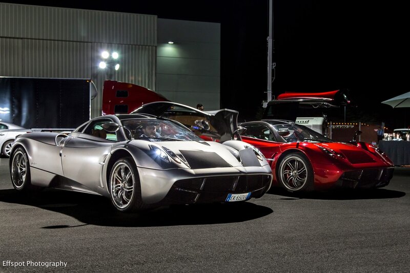 Two Pagani sports cars at night