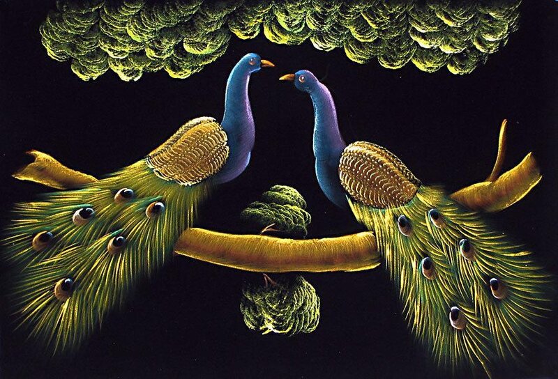 Two peacocks on a branch
