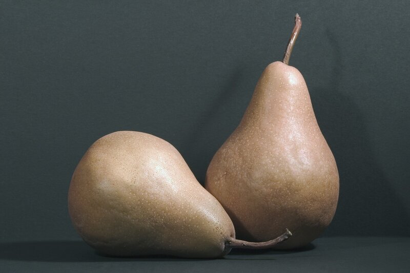 Two pears on a dark surface