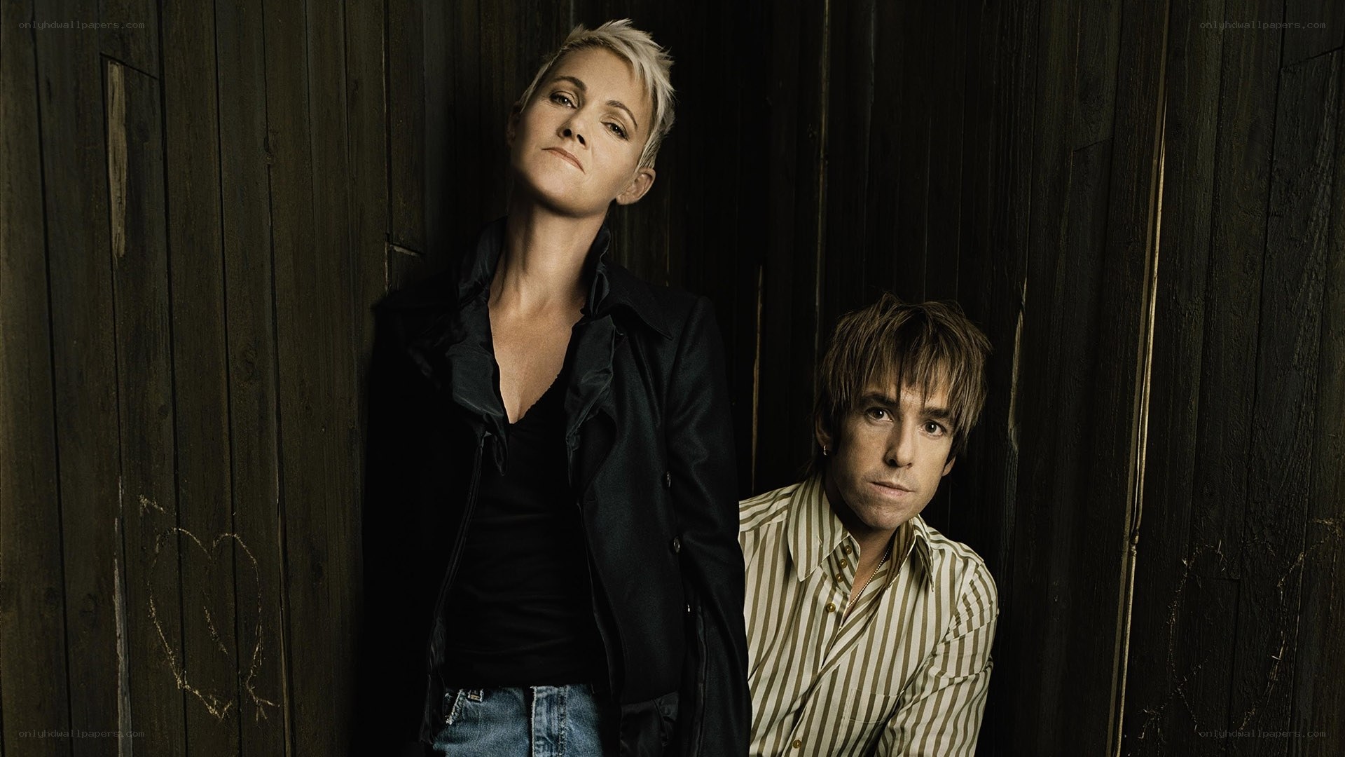 two people against wooden wall