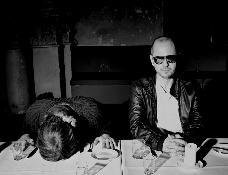 Two people at a table in black and white