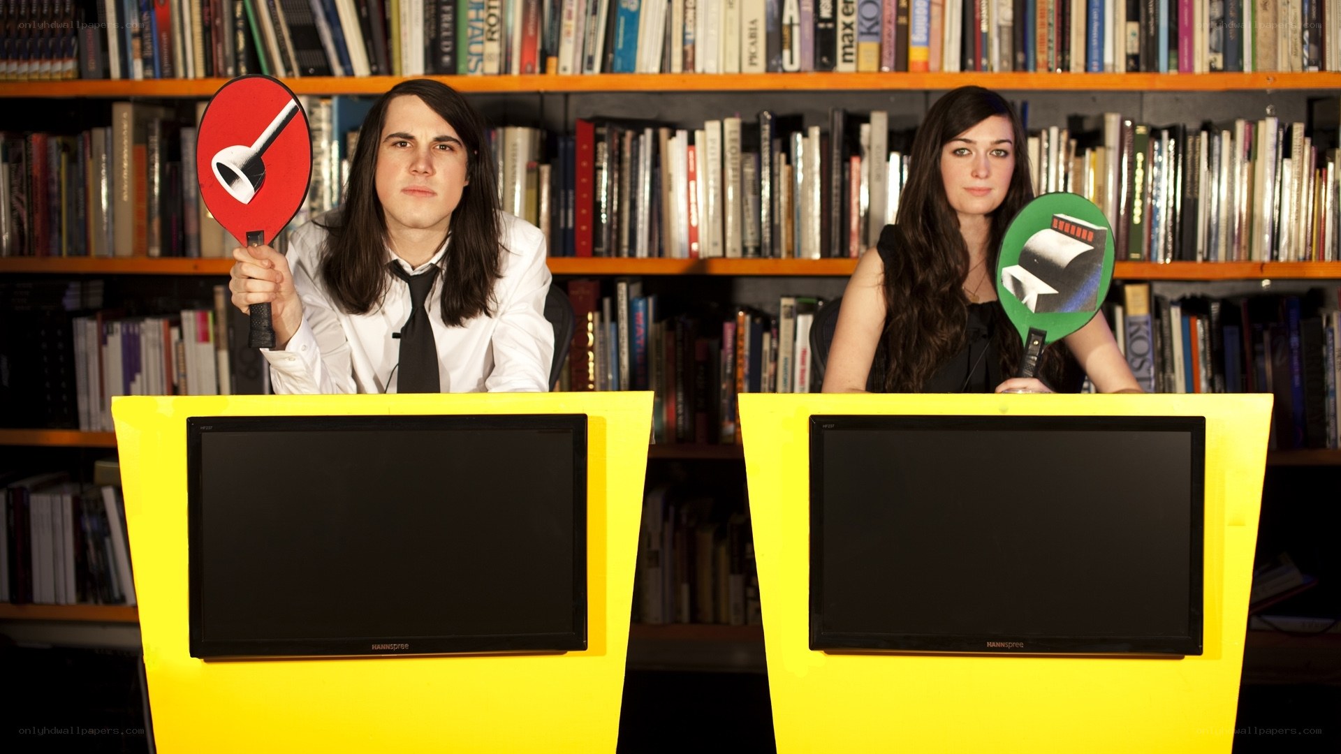 Two people at game show desks