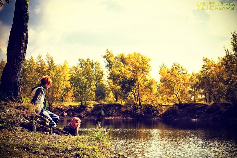 Two people by a lake in autumn