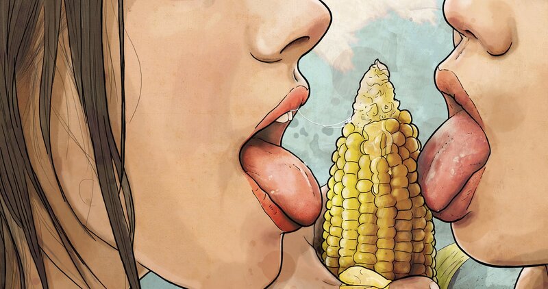 two people eating corn