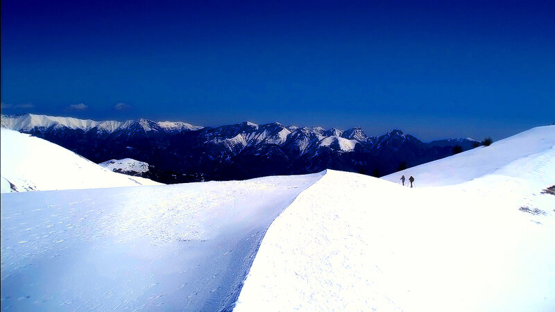 Two People Hiking in Snow
