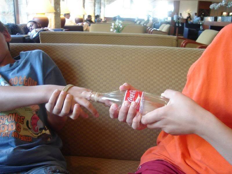 Two People Holding Bottle