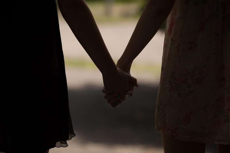 Two People Holding Hands — Black, Intimate, Sunset