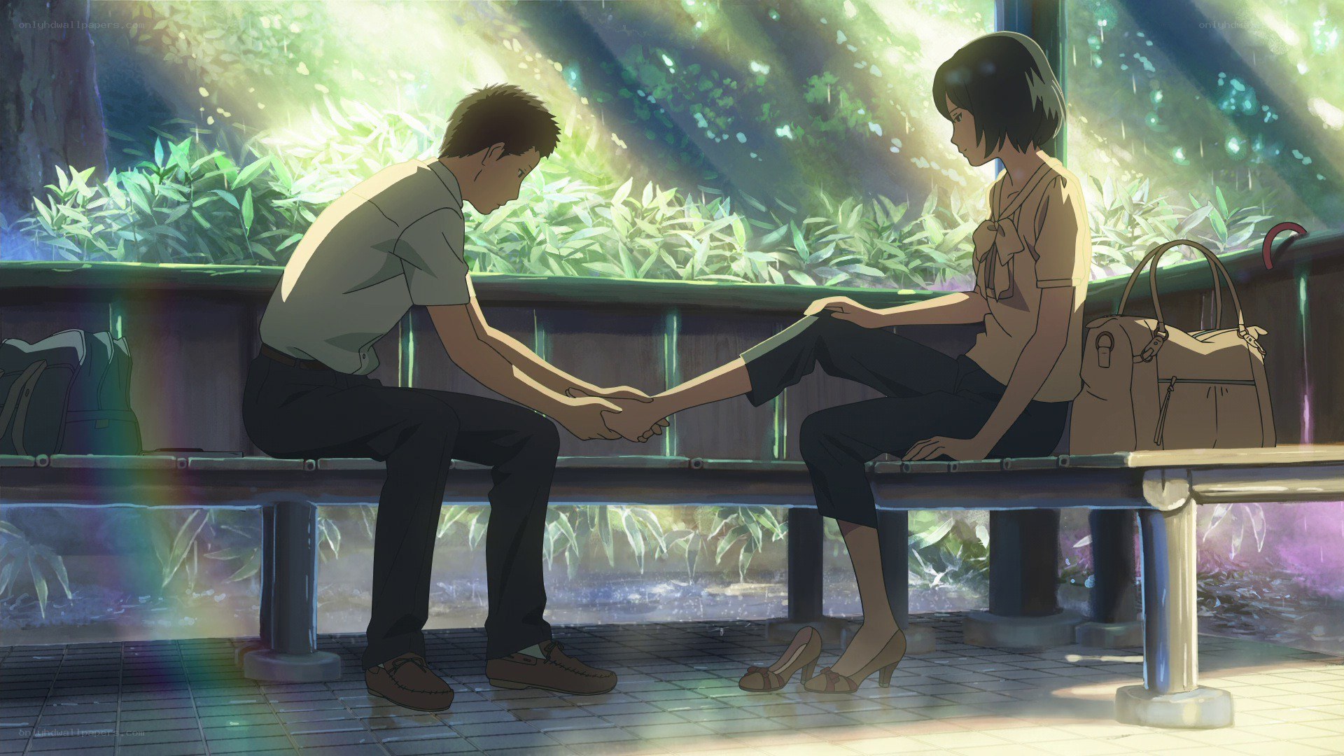 two people holding hands on a bench