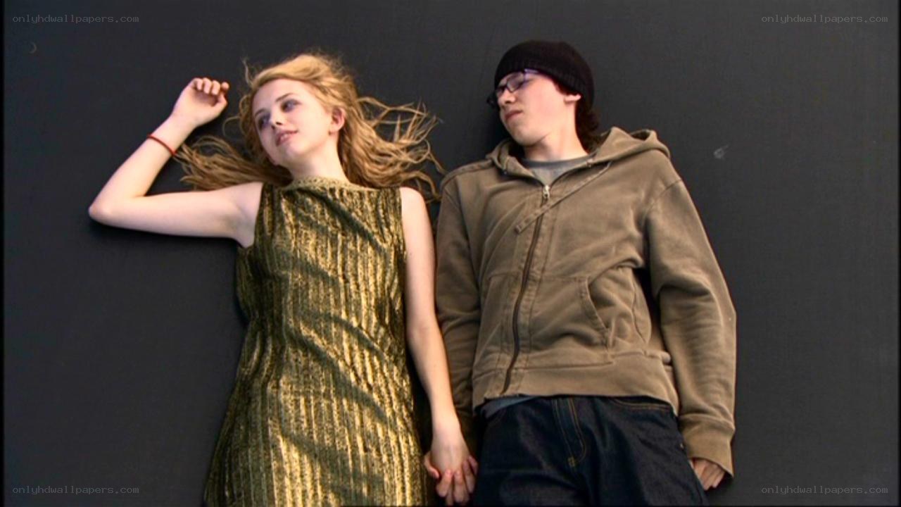 Two people holding hands on floor