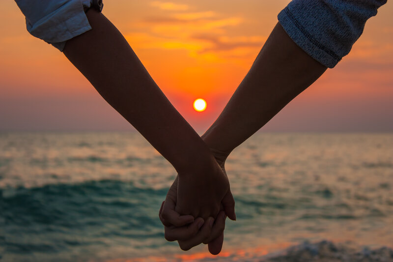 Two People Holding Hands — Orange, Serene