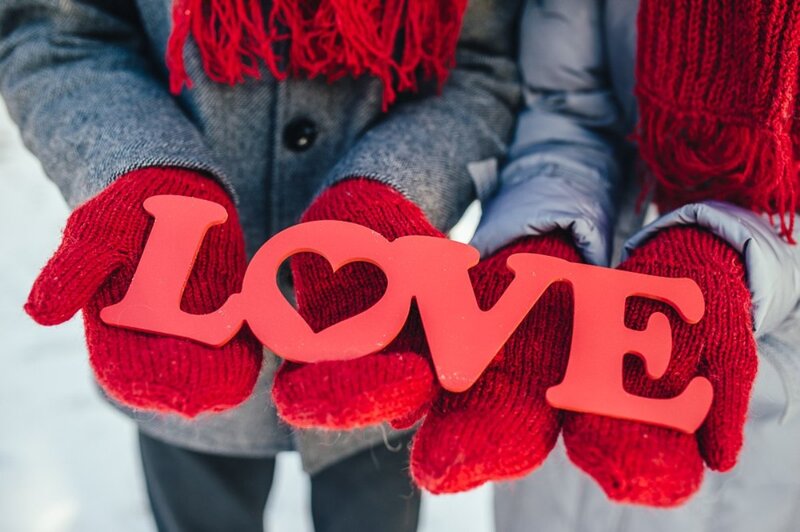 Two People Holding Love Sign