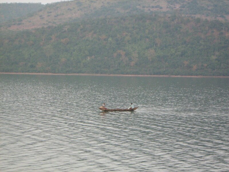 Two People in a Boat — Green, Calm, Photograph