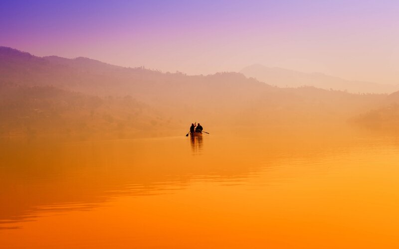 Two People in a Canoe — Orange, Serene, Sunset