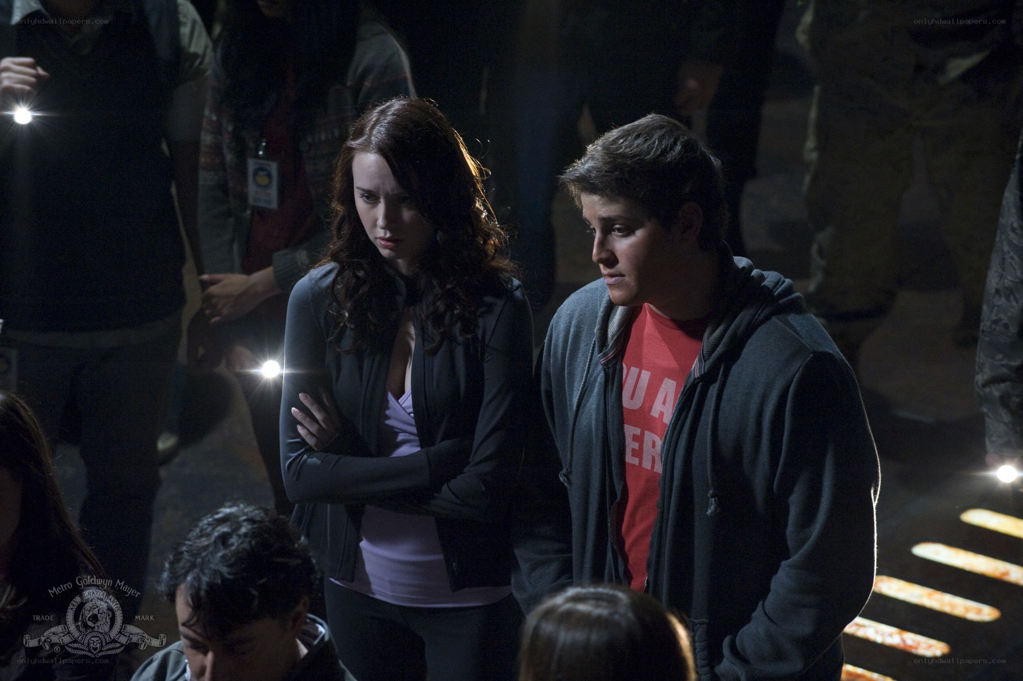 Two people in a dark crowd