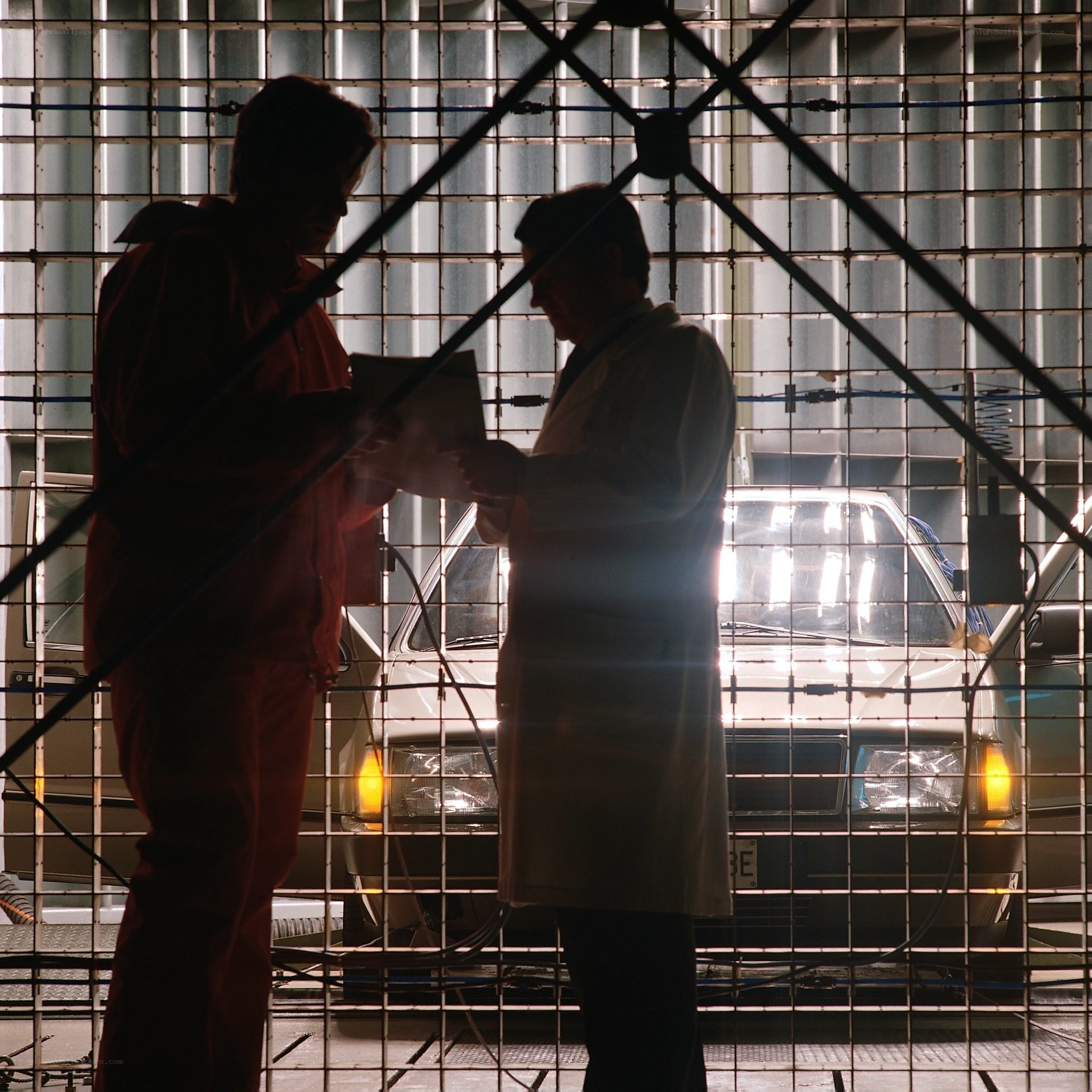 Two people in a lab with car
