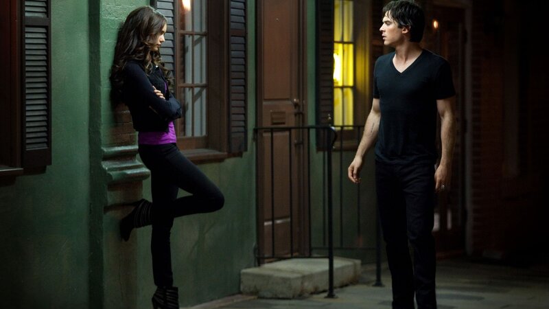 two people in a nighttime alley