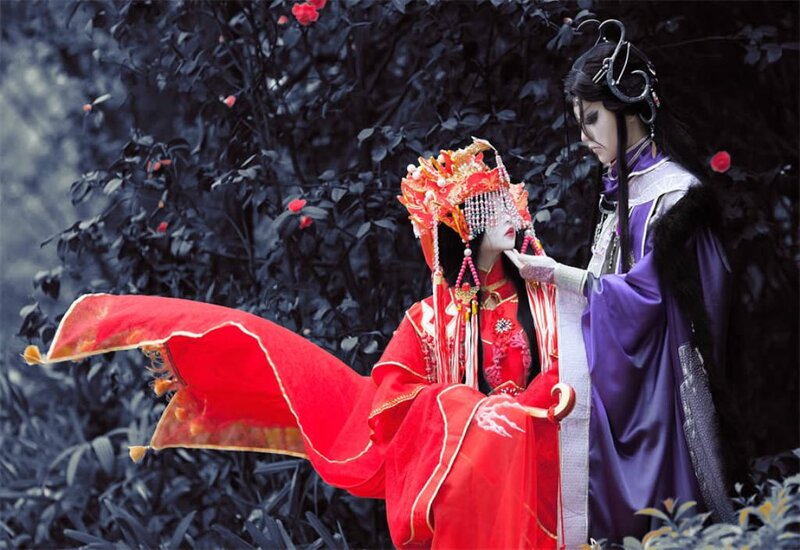 Two People in Costumes — Red, Dramatic