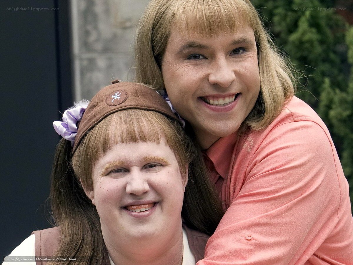Two people in costumes smiling