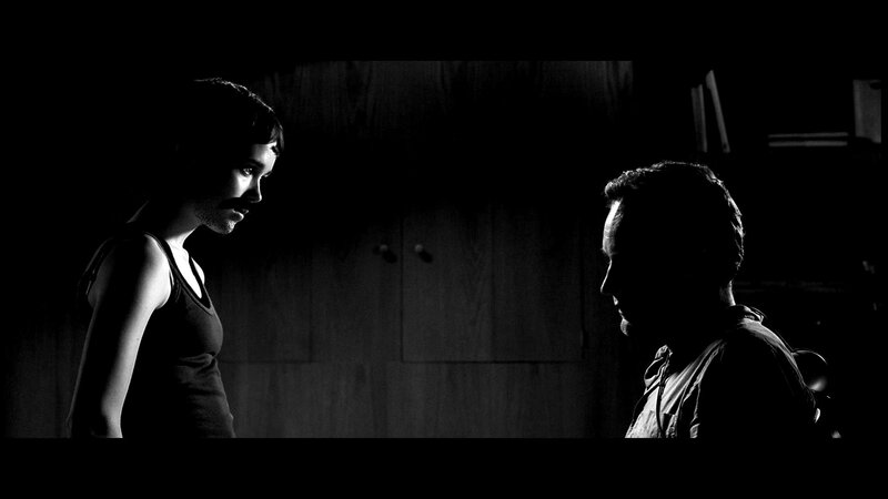 two people in dim light