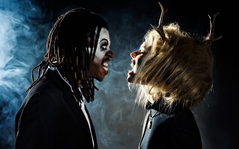 Two people in dramatic makeup face off