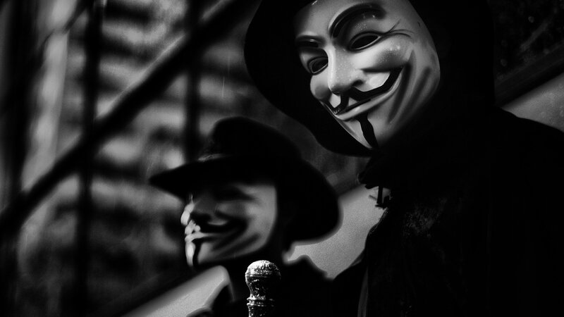 Two people in Guy Fawkes masks