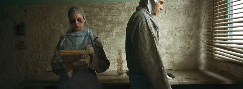 Two people in protective suits