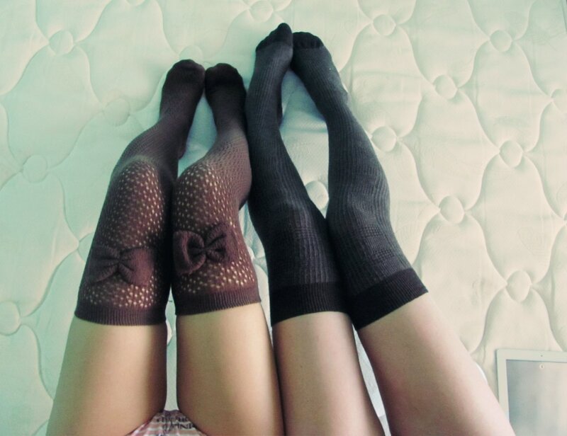 two people in socks on a bed