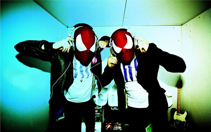 Two people in Spider-Man masks with headphones