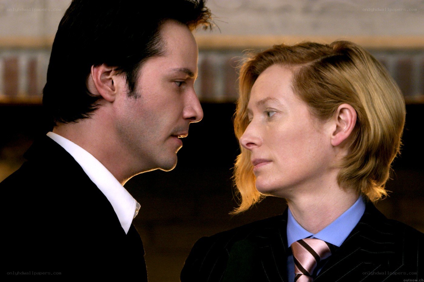 two people in suits facing each other