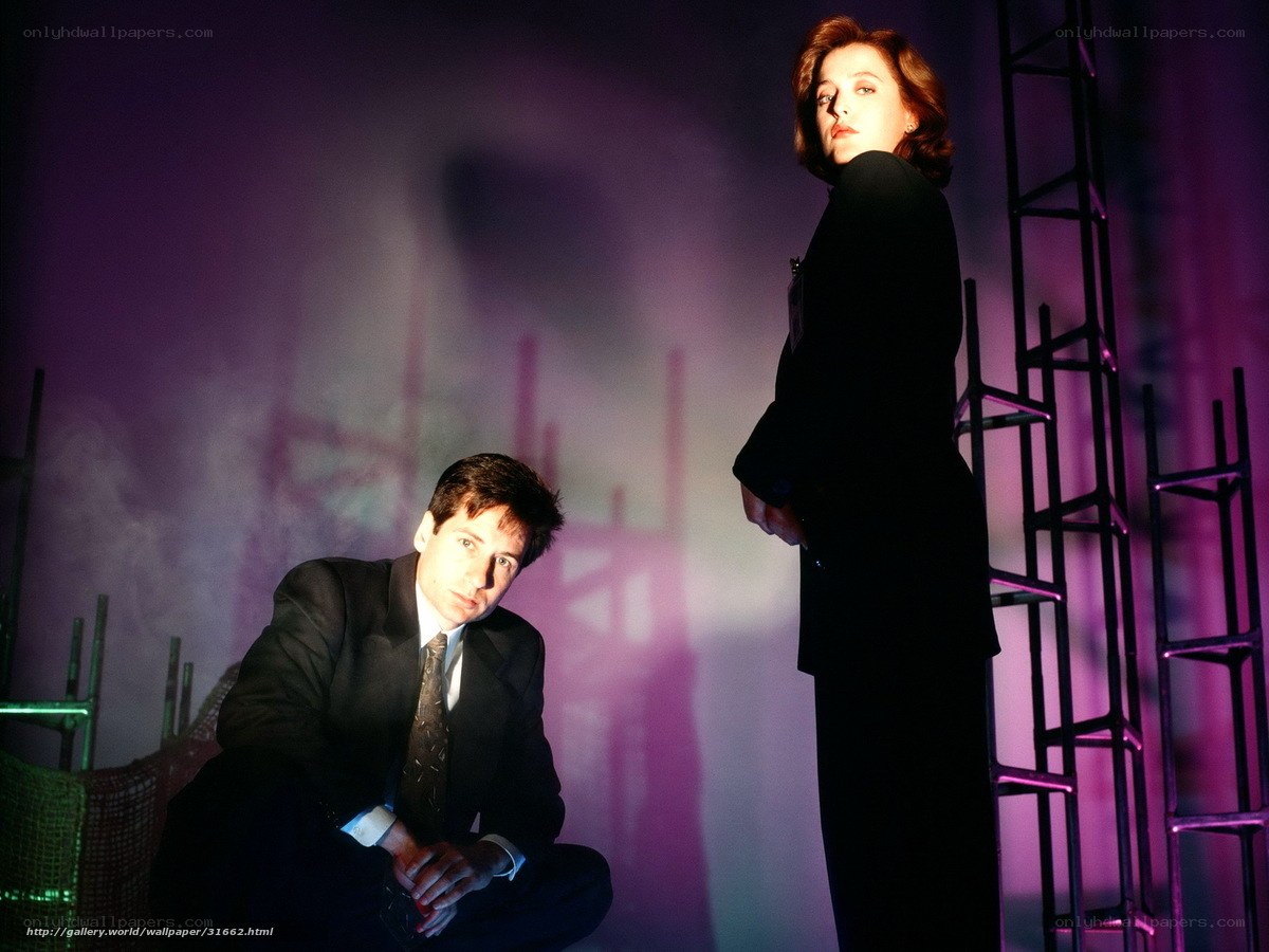 two people in suits on stage