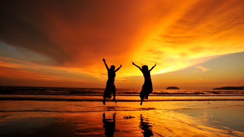 Two People Jumping — Orange