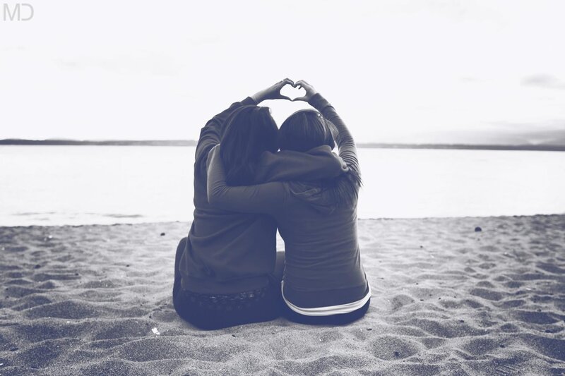 Two people making a heart shape