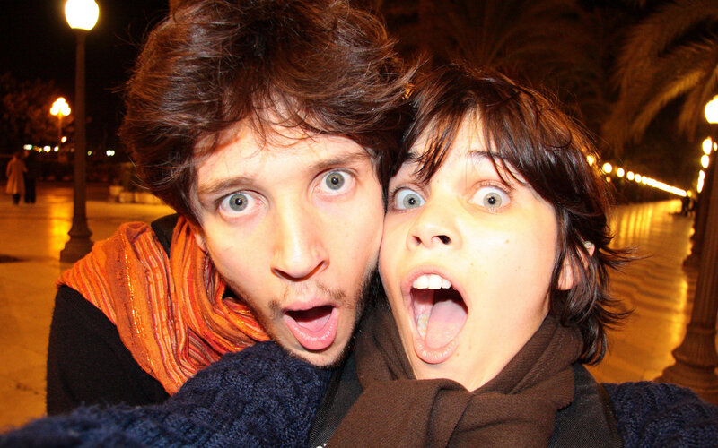 two people making funny faces at night