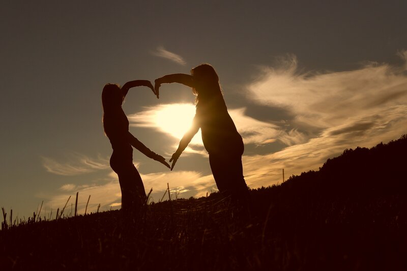 Two People Making Heart Shape — Orange